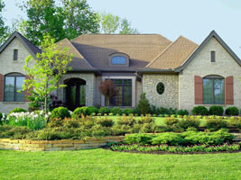 Stone terraces and lush, but low maintenance plantings solve front drainage problems while adding a variety of native plantings and cut flowers for these ambitious do-it-yourselfers.