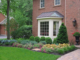 A variety of foliage colors and textures keep the entrance interesting year round.